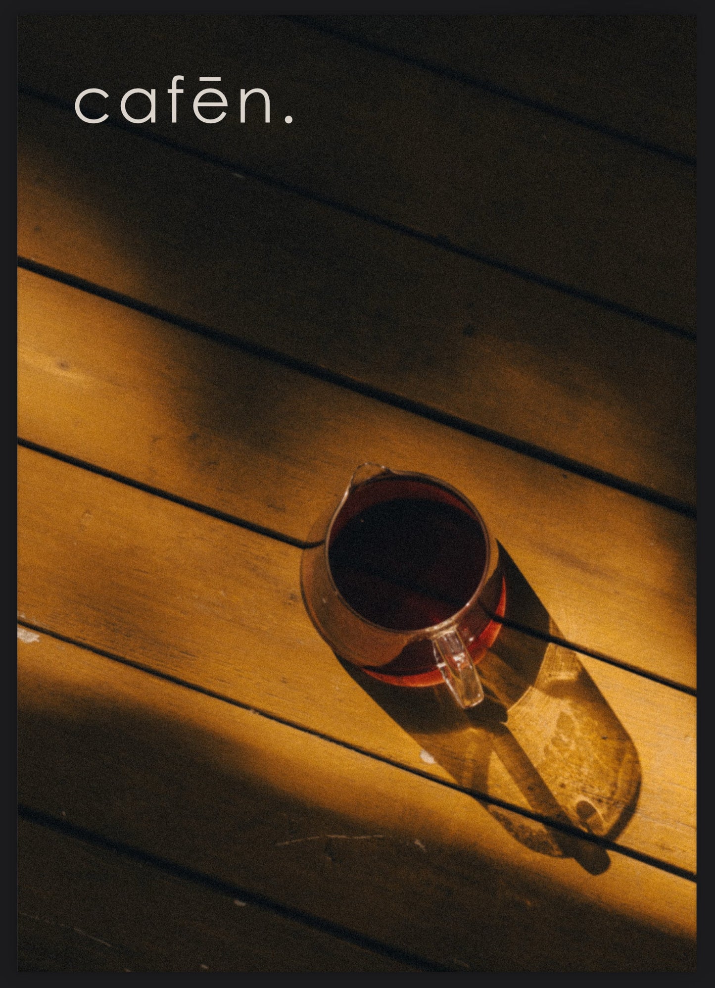Cup of coffee on a wooden surface with 'cafen' branding.